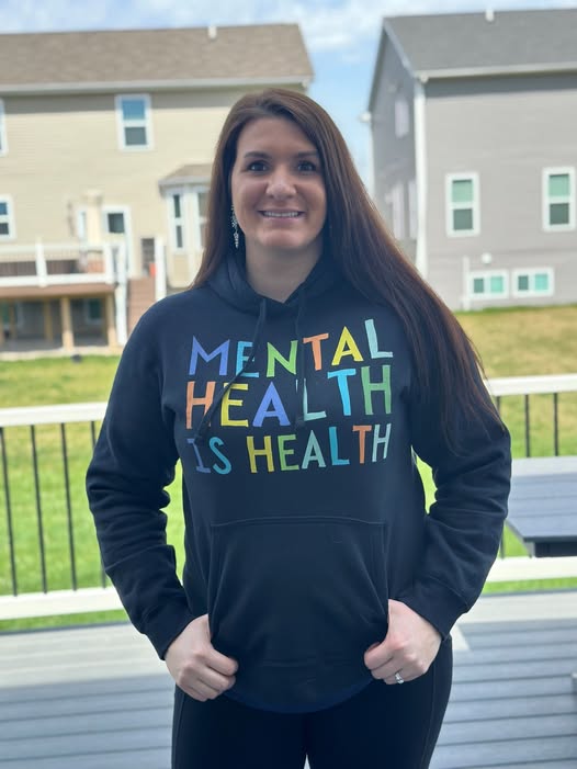 Gretchen O'Hair wearing a Mental Health Is Health sweatshirt